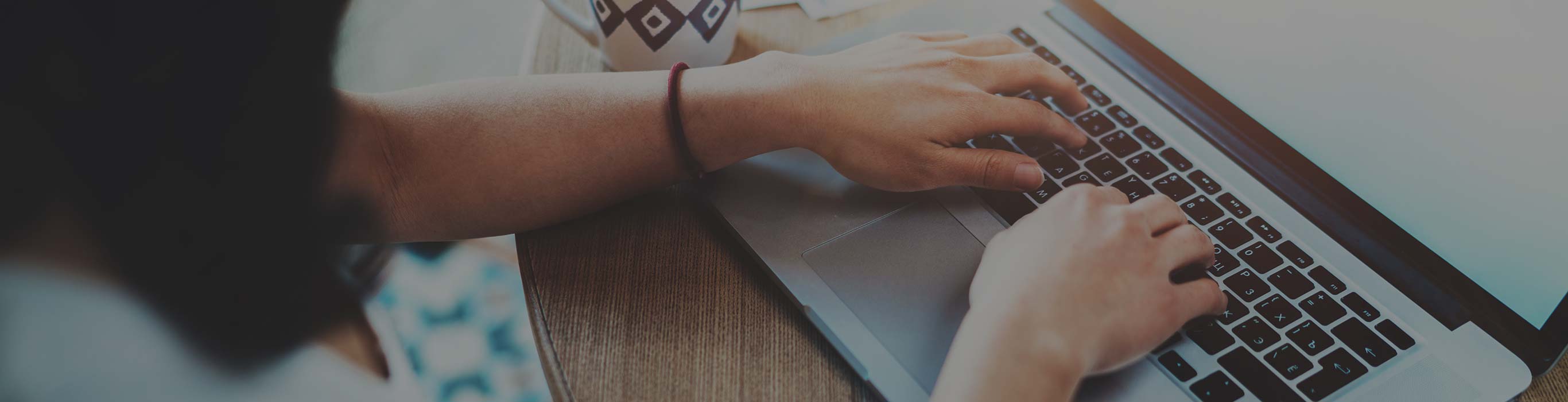 Woman type a blog on a laptop.