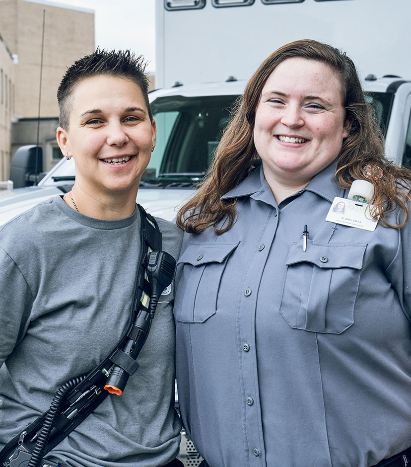 Two female EMTs smiling.