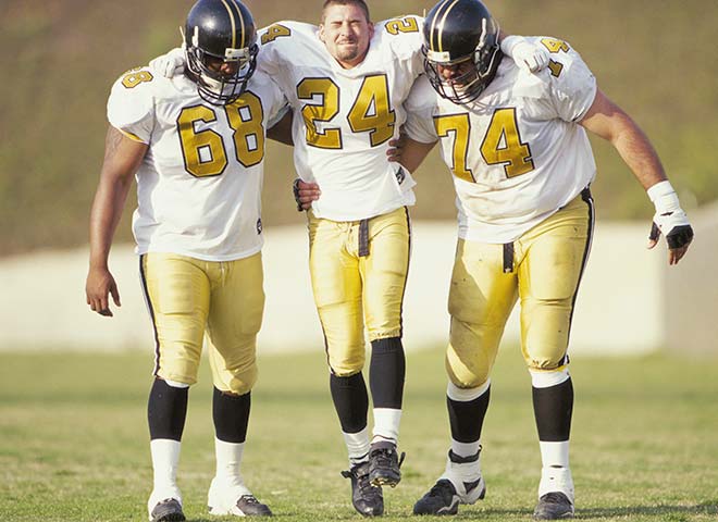 Injured player being helped off the field.