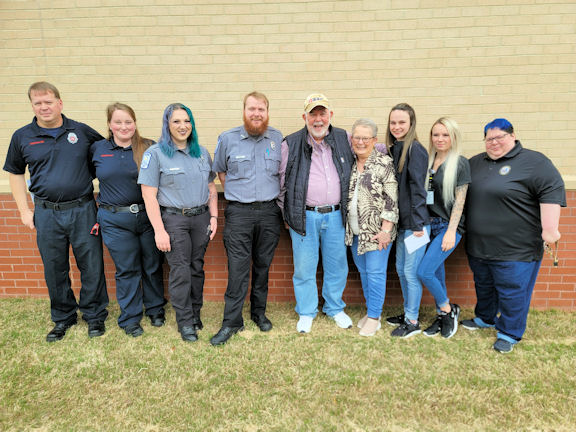 A group of gratitude: From left, firefighter II David Scruggs and firefighter Isabella Fritz with Carroll County Fire Rescue; EMT Sydney Chafin and paramedic Bailey Morgan with West Georgia Ambulance; residents Charles and Becky Allen; and Carroll County Emergency 911 dispatchers Lacie Lambert, Stephanie Whitlow and Melissa Smith. In early May, when Becky Allen went into cardiac arrest, her husband of 57 years, Charles Allen, called 911, setting of a chain of rescue that involved the first responders and dispatchers pictured. 